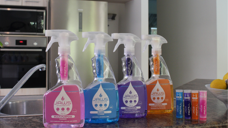 JAWS Cleaners and JAWS Refills displayed on a kitchen benchtop, alongside a bowl of lemons.