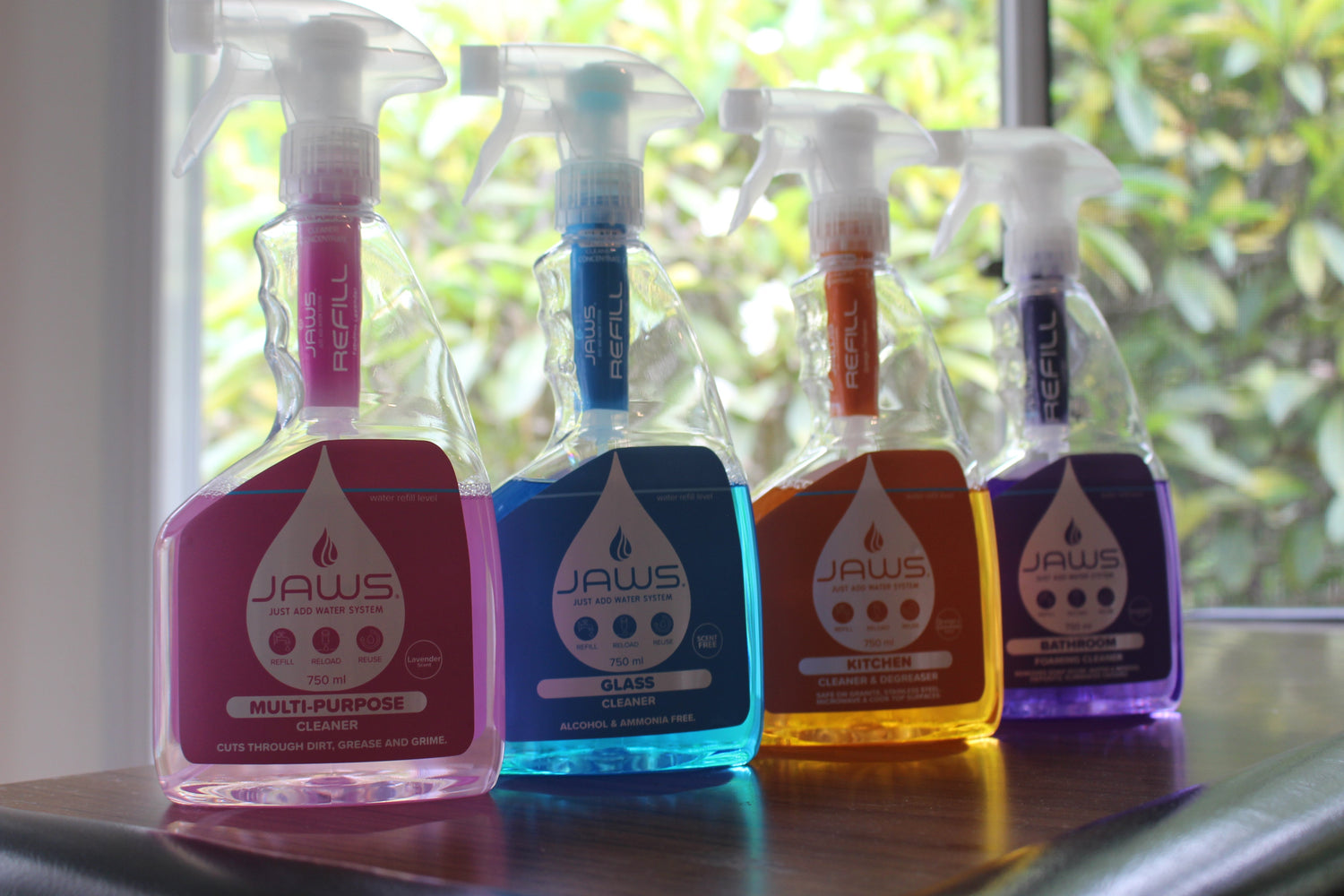 JAWS Cleaners lined up on the counter, ready to use eco-friendly refillable cleaners.